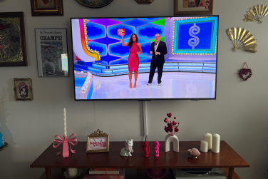 "The Price is Right" scene on wall-mounted TCL QM6K TV