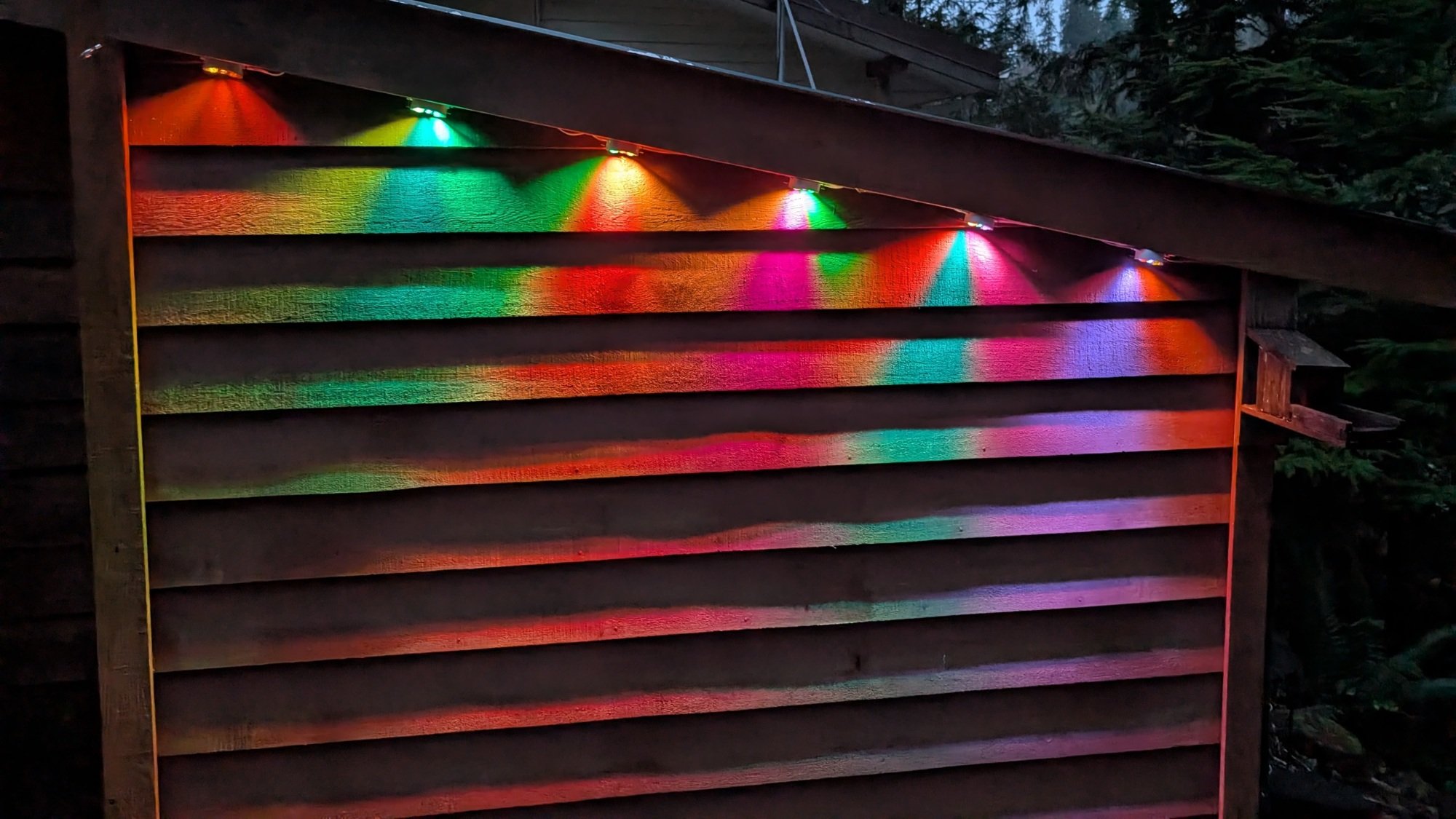 the Govee Permanent Outdoor Lights Prism project on the side of a building
