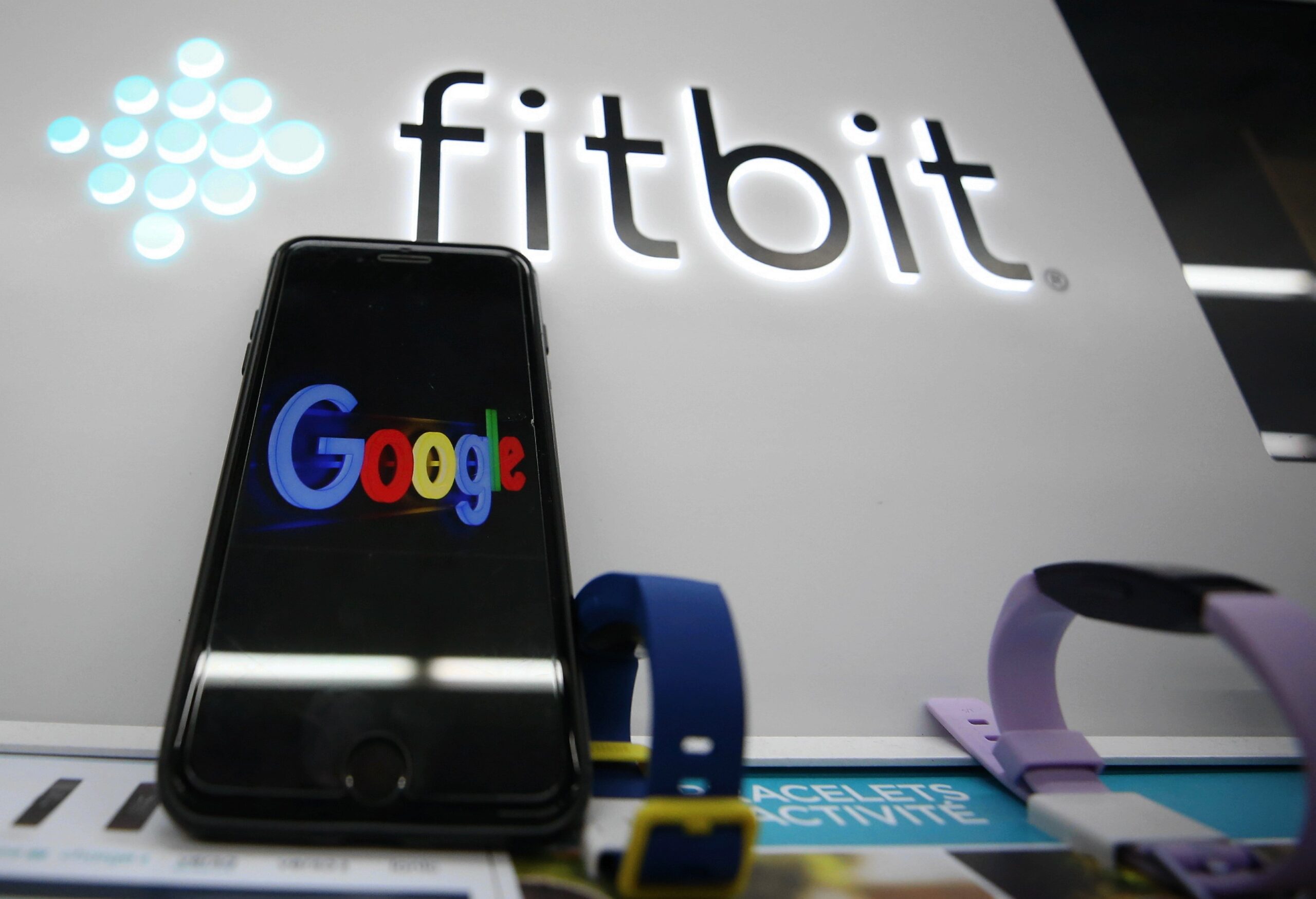 fitbit logo with a google phone in front of it