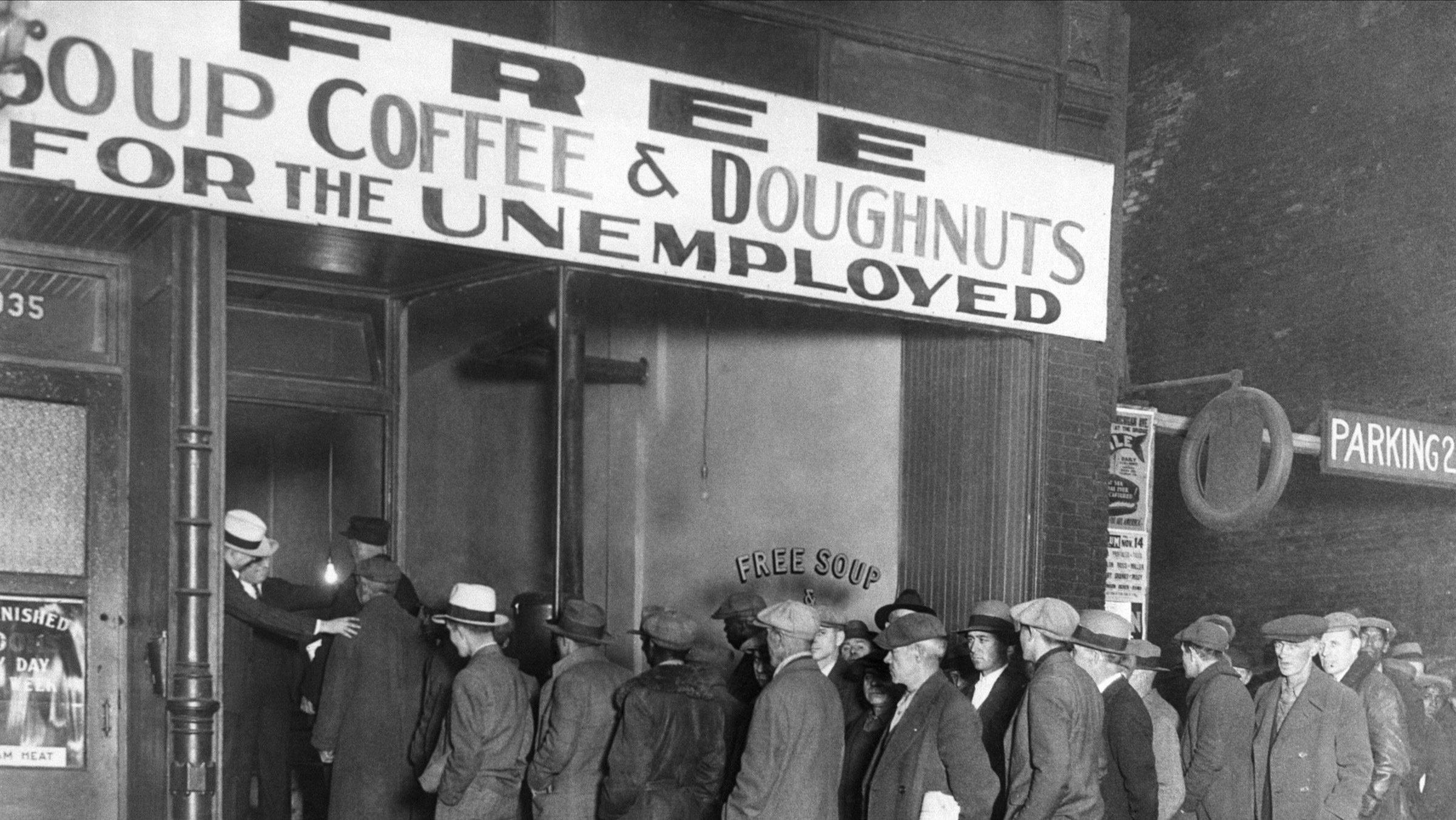 men line up outside a breadline during the great depression
