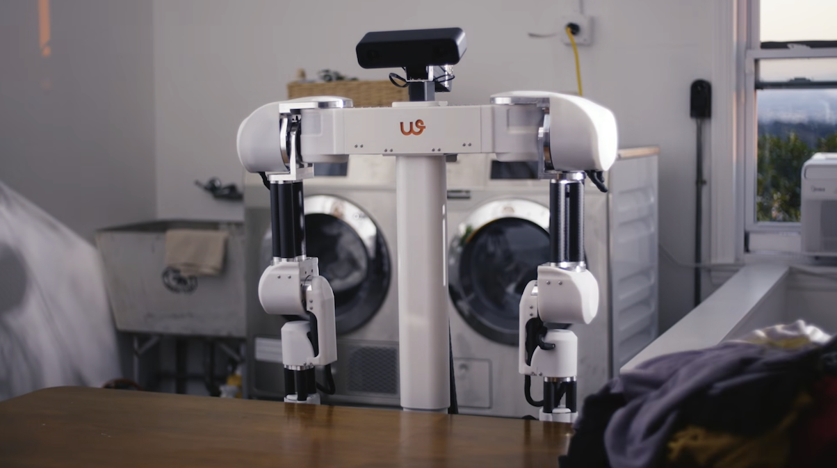 Weave Isaac 0 robot in front of laundry pile