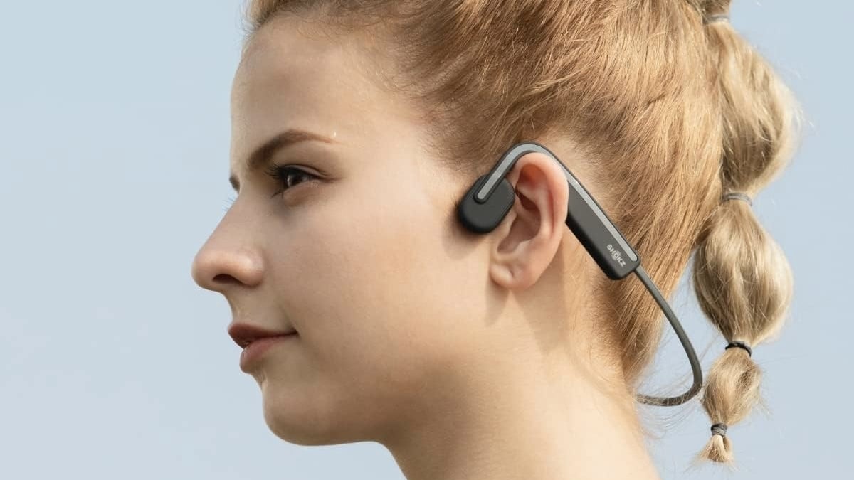 woman wearing shokz openmove headphones outside