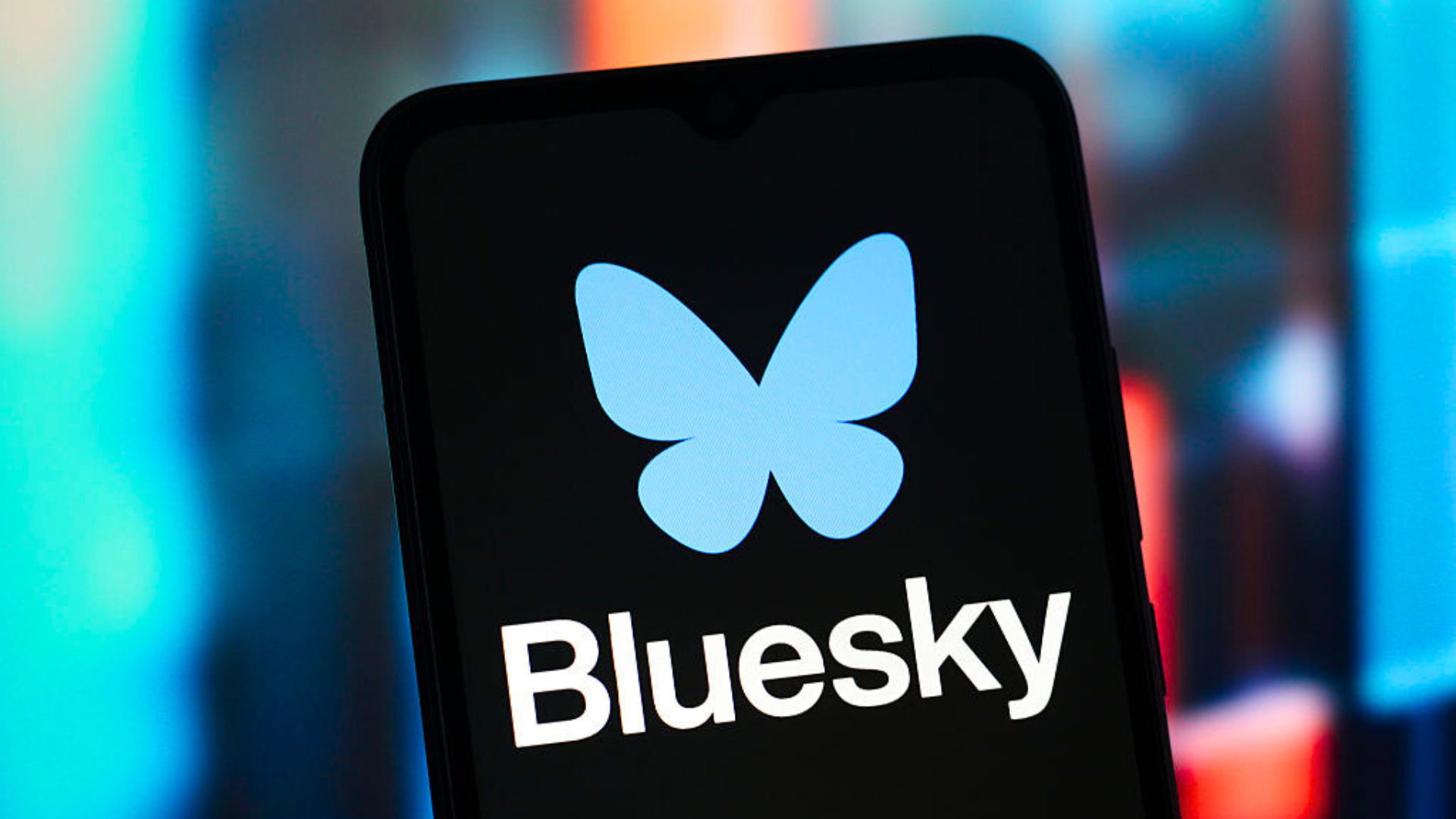 The Bluesky logo is seen displayed on a smartphone screen.