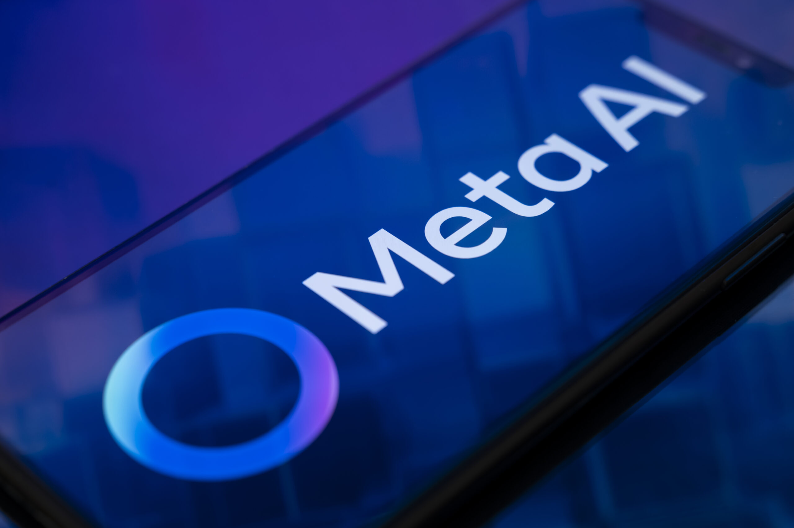 A phone screen displays a glowing blue Meta AI logo.