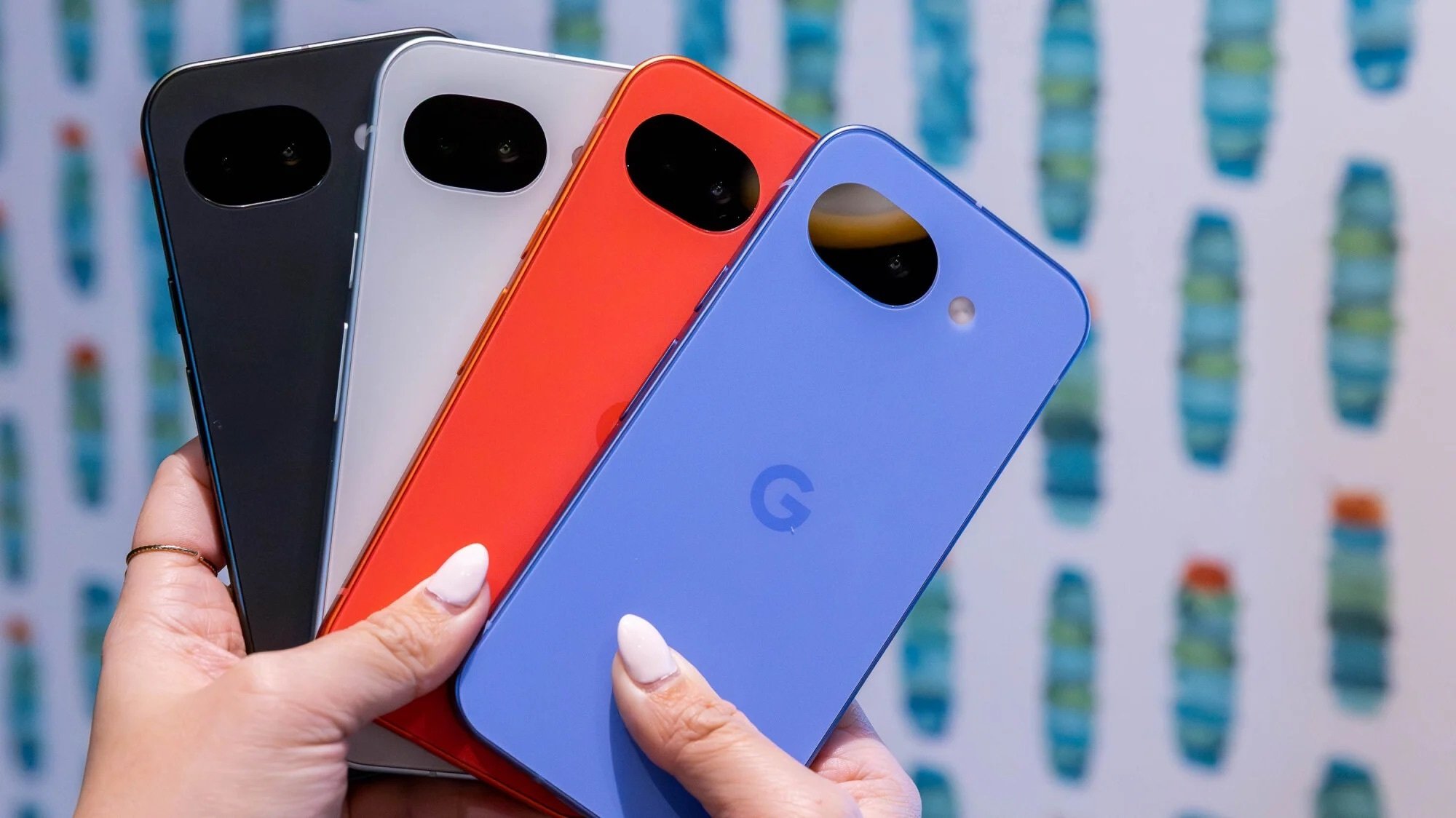 hands holding up all four colors of the Google Pixel 10a