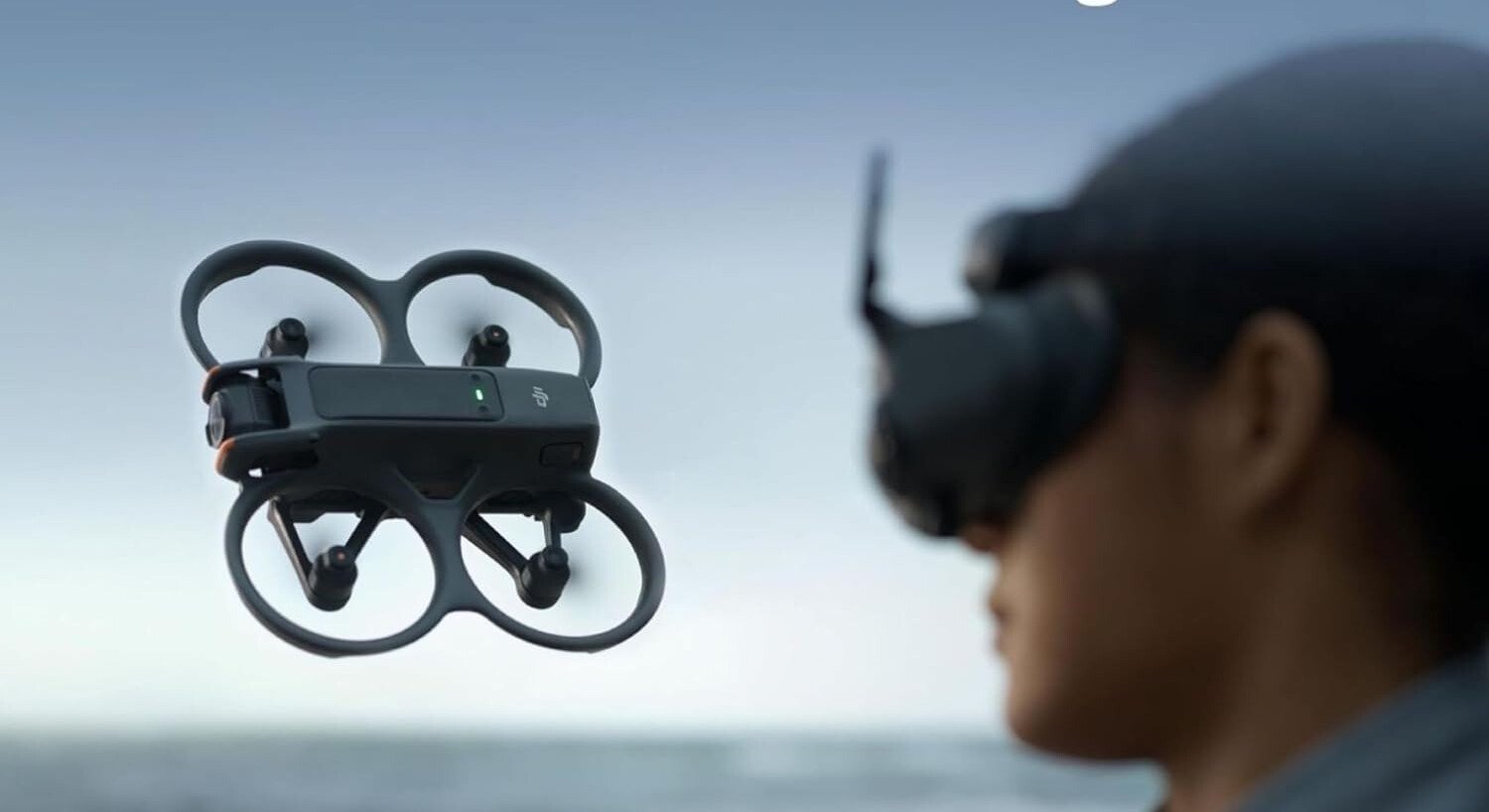 the DJI Avata 2 drone flies in front a person using the DJI Googles 3 to view what the drone is seeing while flying outside