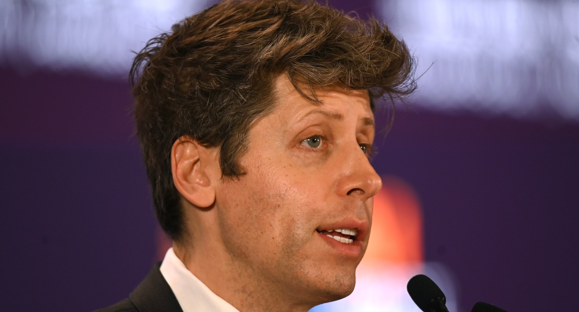 Sam Altman speaking at a microphone