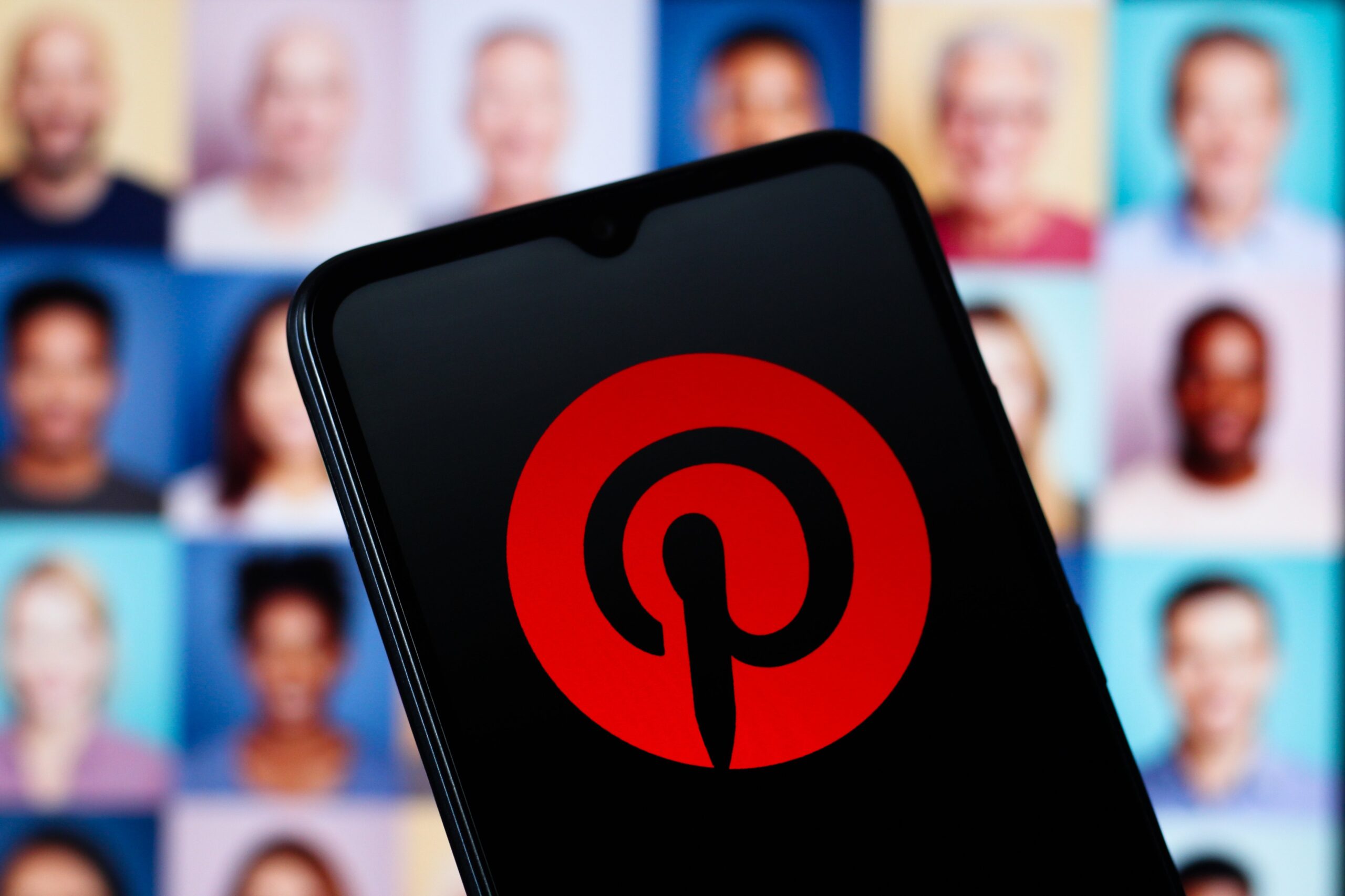 A phone shows a red and black Pinterest logo.