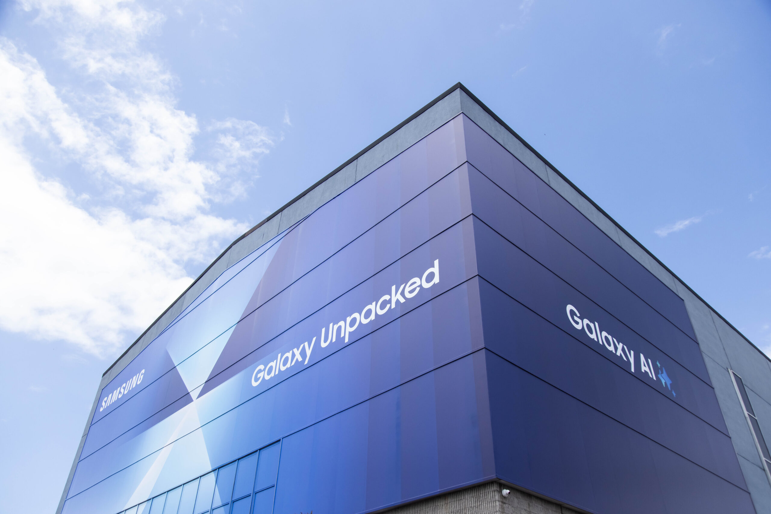 a building with a galaxy unpacked logo on a billboard