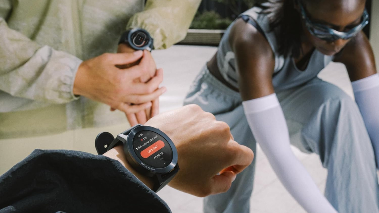 three athletes wearing CMF Watch 3 Pro in different colors