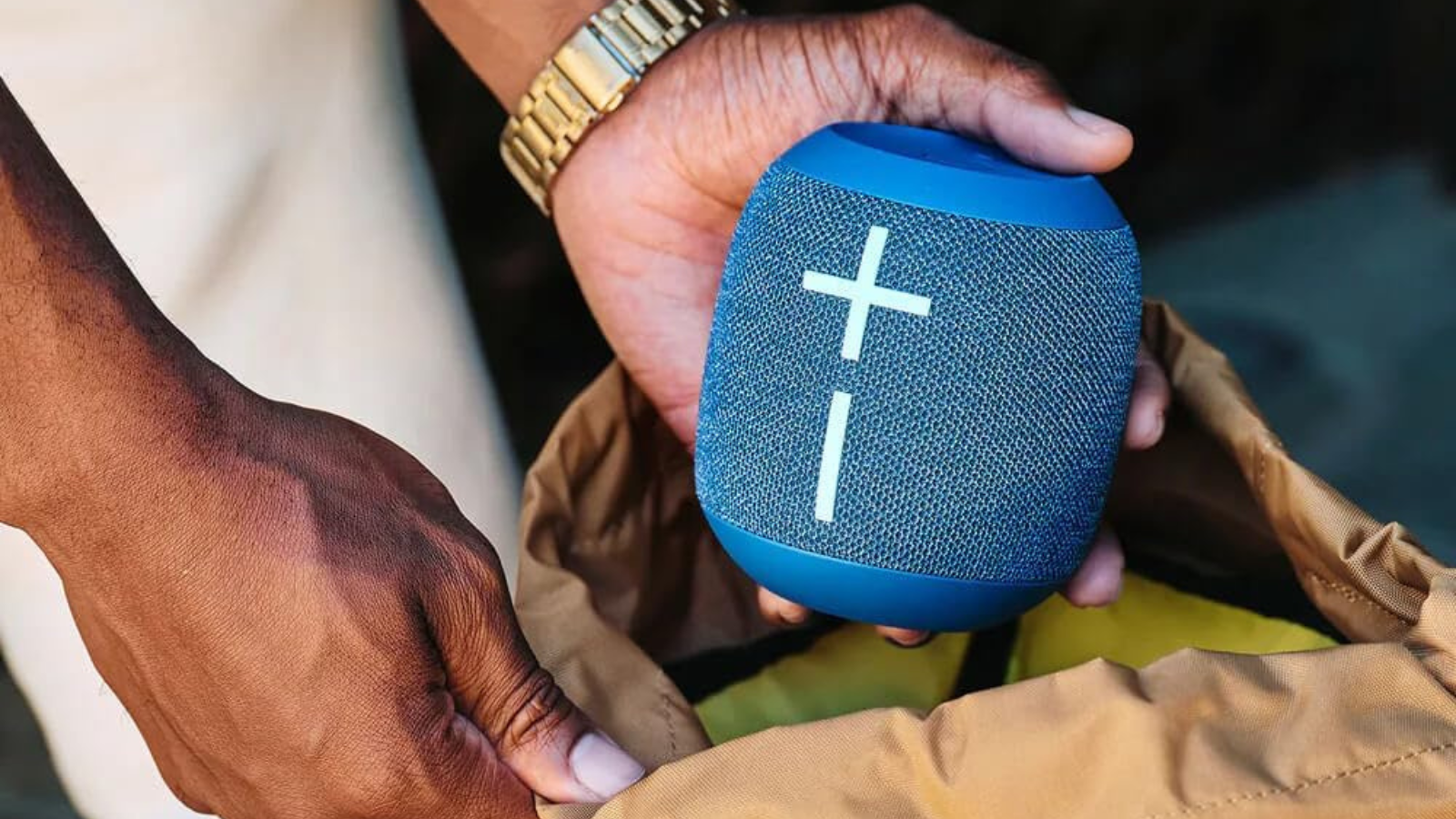 close up of hands holding blue Ultimate Ears Wonderboom 4 speaker