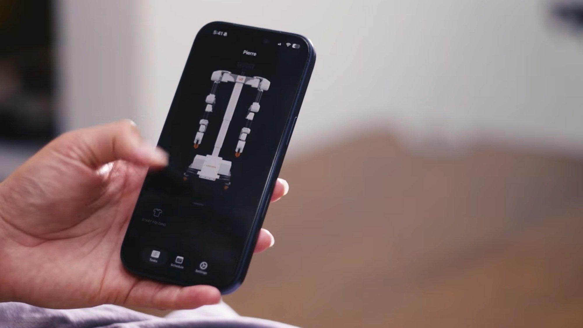 person holding phone with robotics app on screen