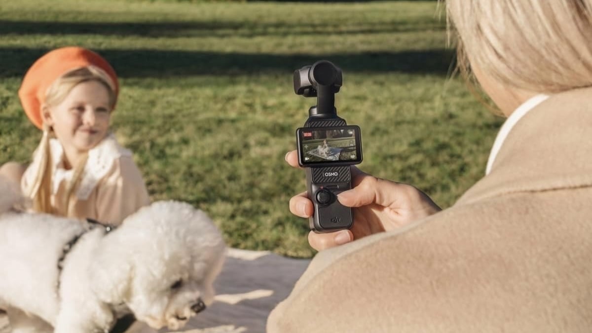 person filming dog and child outside with DJI Osmo pocket 3