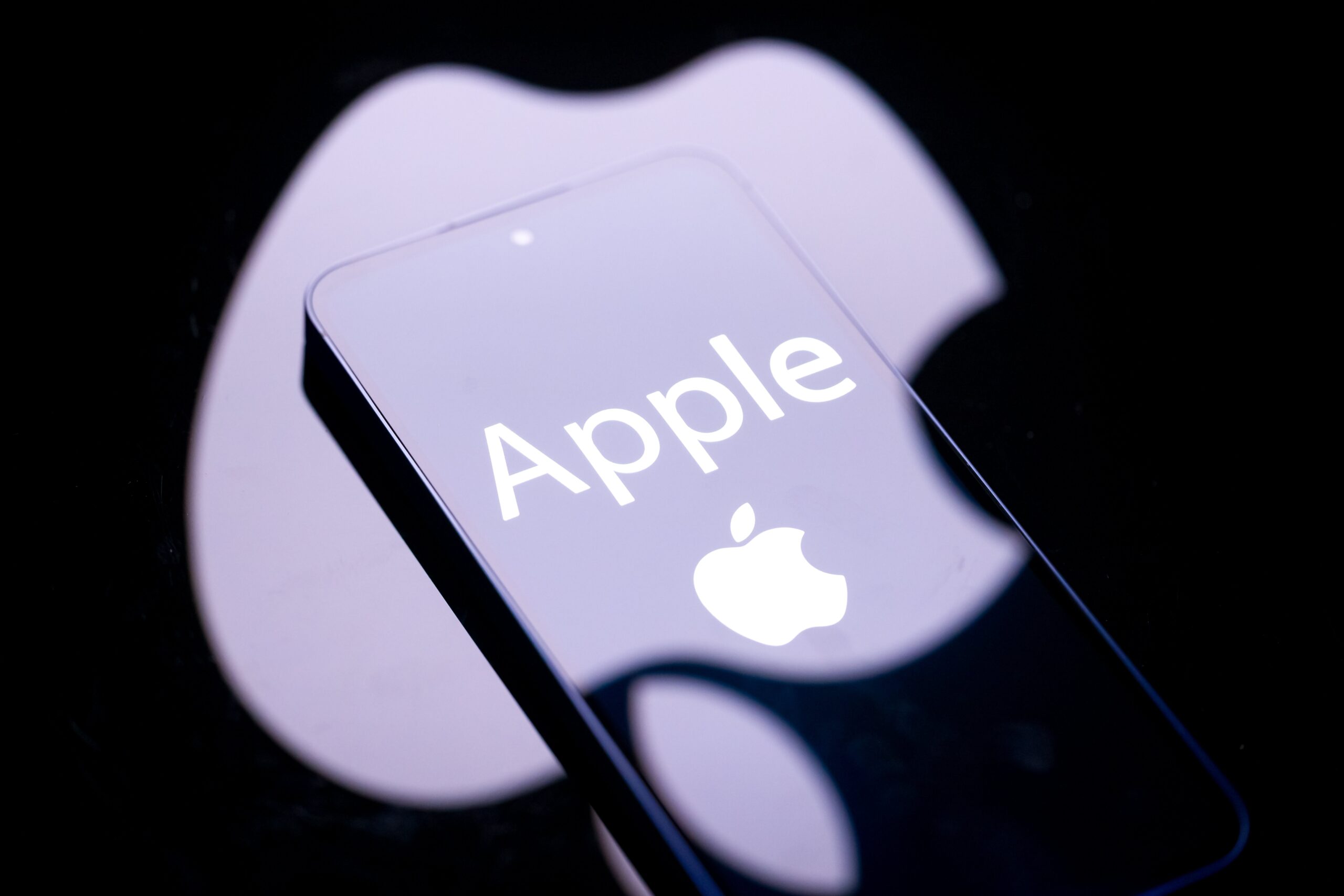apple logo over a smartphone with black background