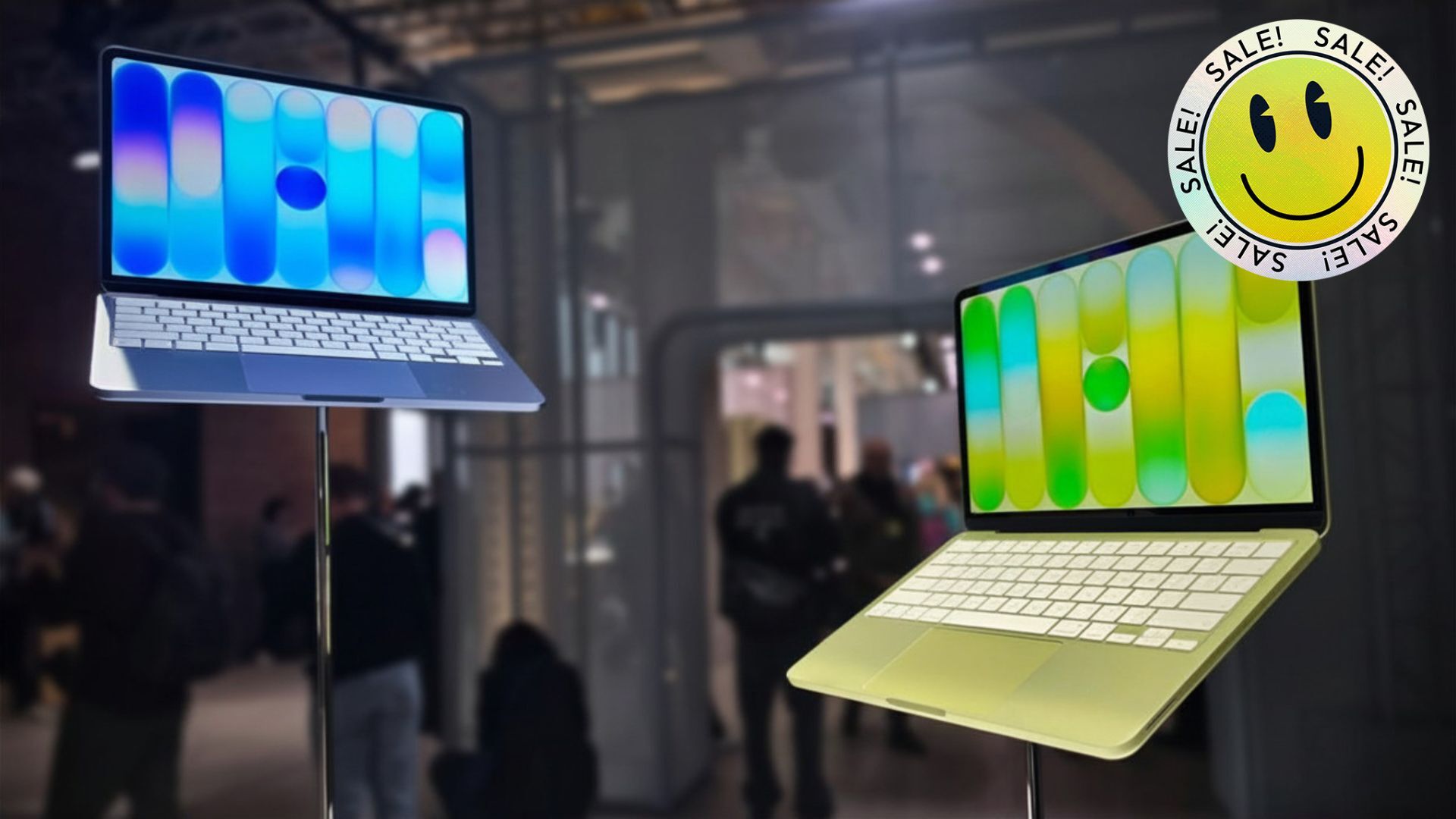 two macbook neos on display with smiley face sticker that reads 'sale'