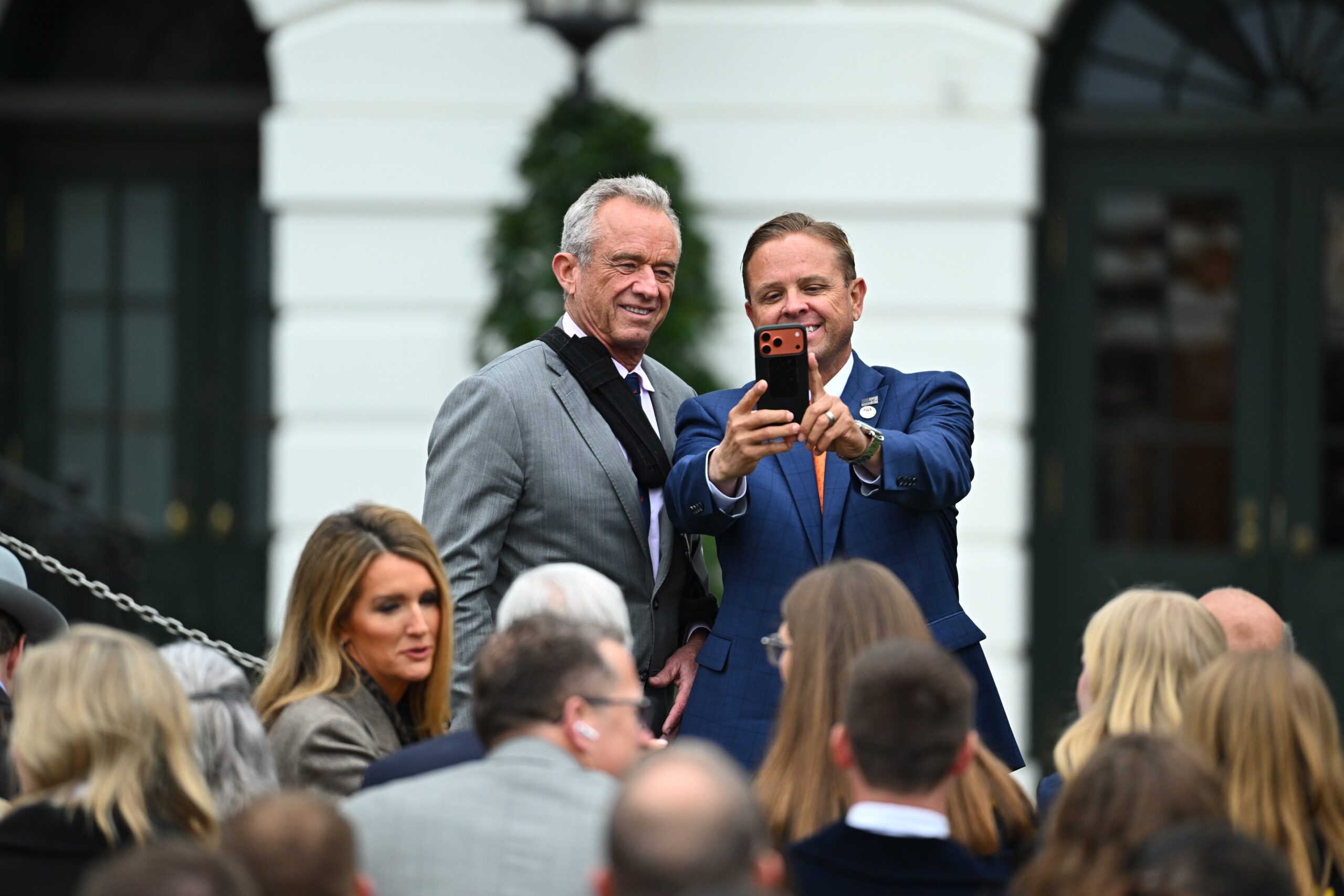 RFK Jr. takes a selfie with an event attendee on the White House lawn.