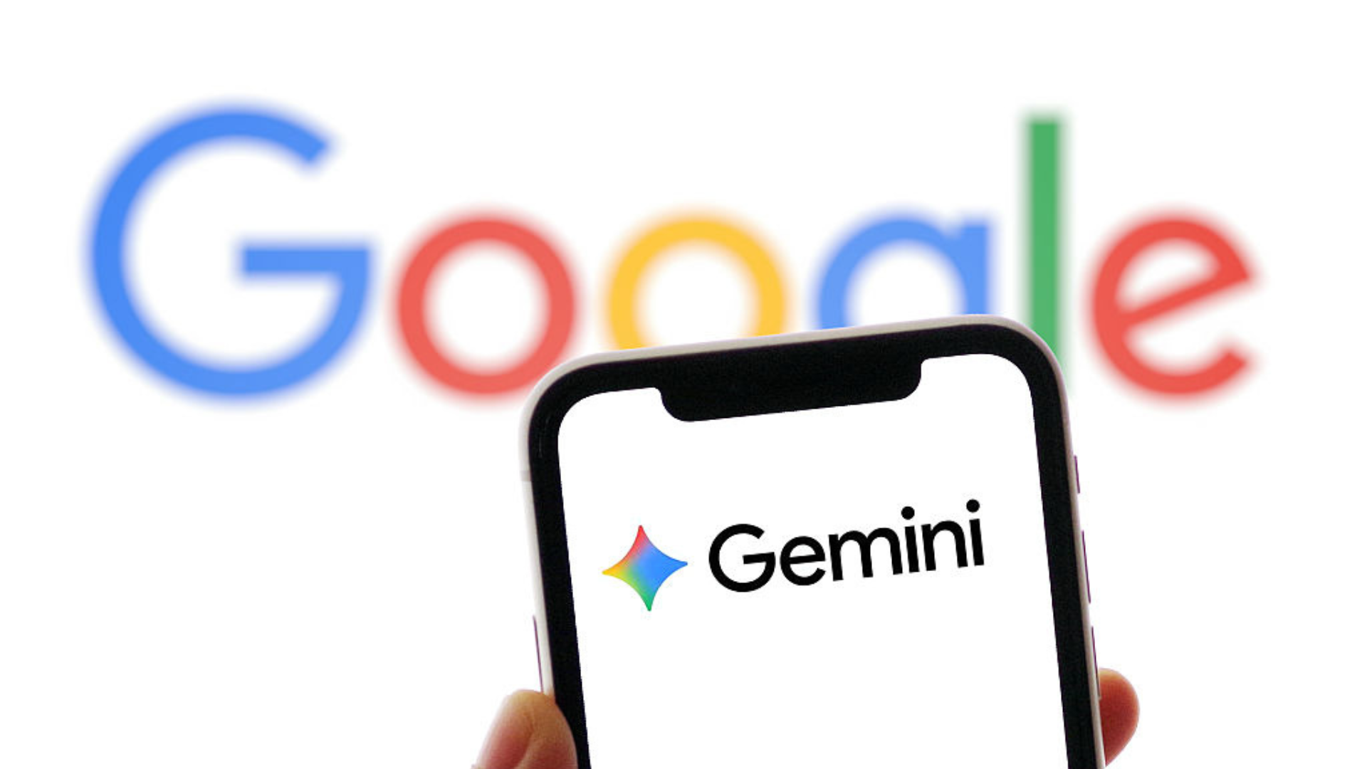 The logo of Gemini is displayed on a smartphone screen with the logo of Google in the background.