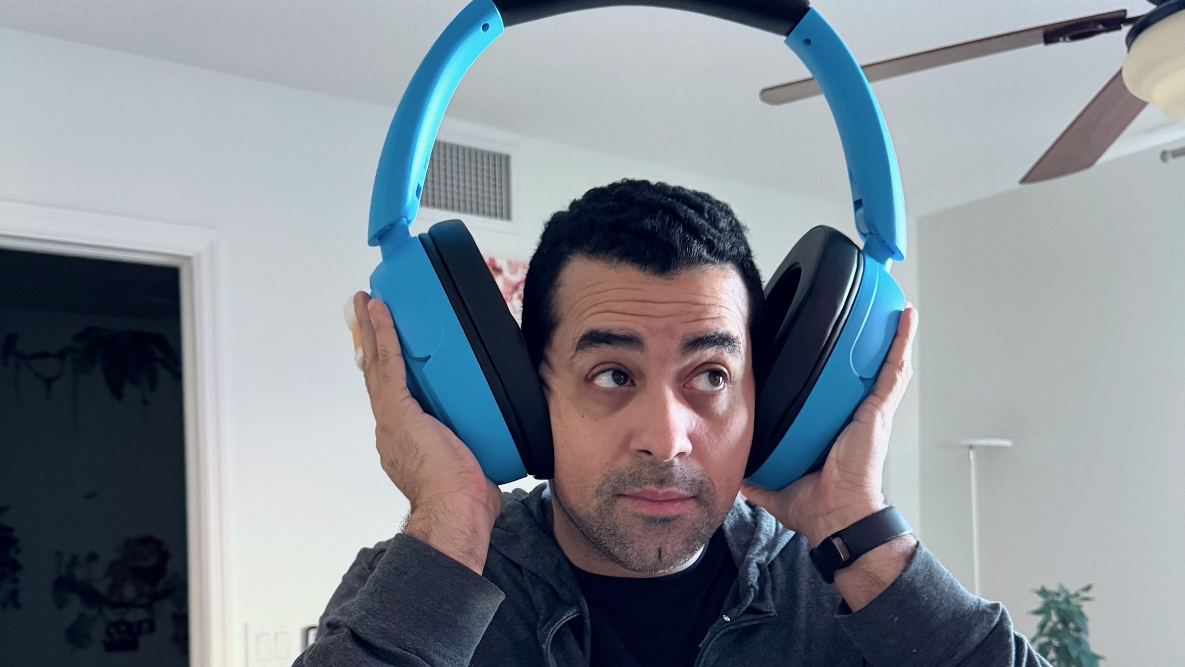 author wearing jlab oversized headphone speakers