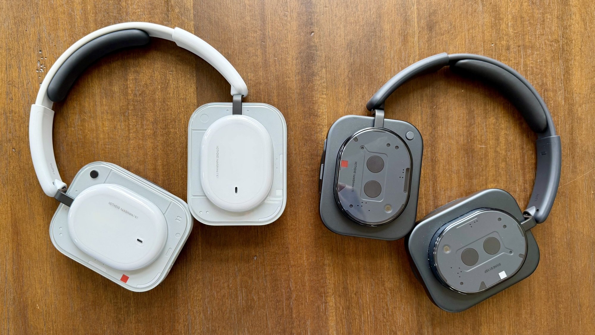 white nothing headphone (a) next to black nothing headphone (1)