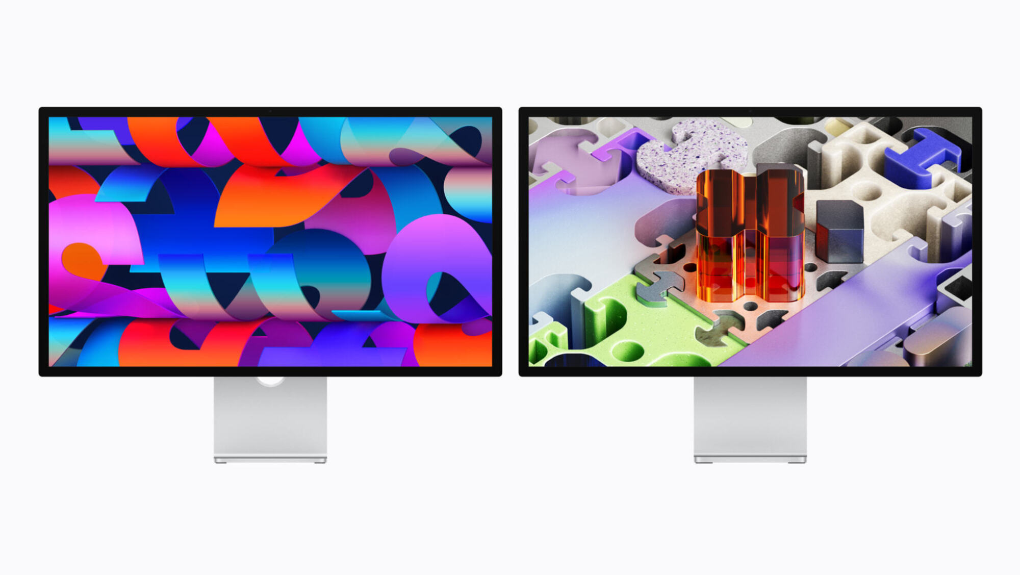 two apple studio displays with colorful graphics on screen