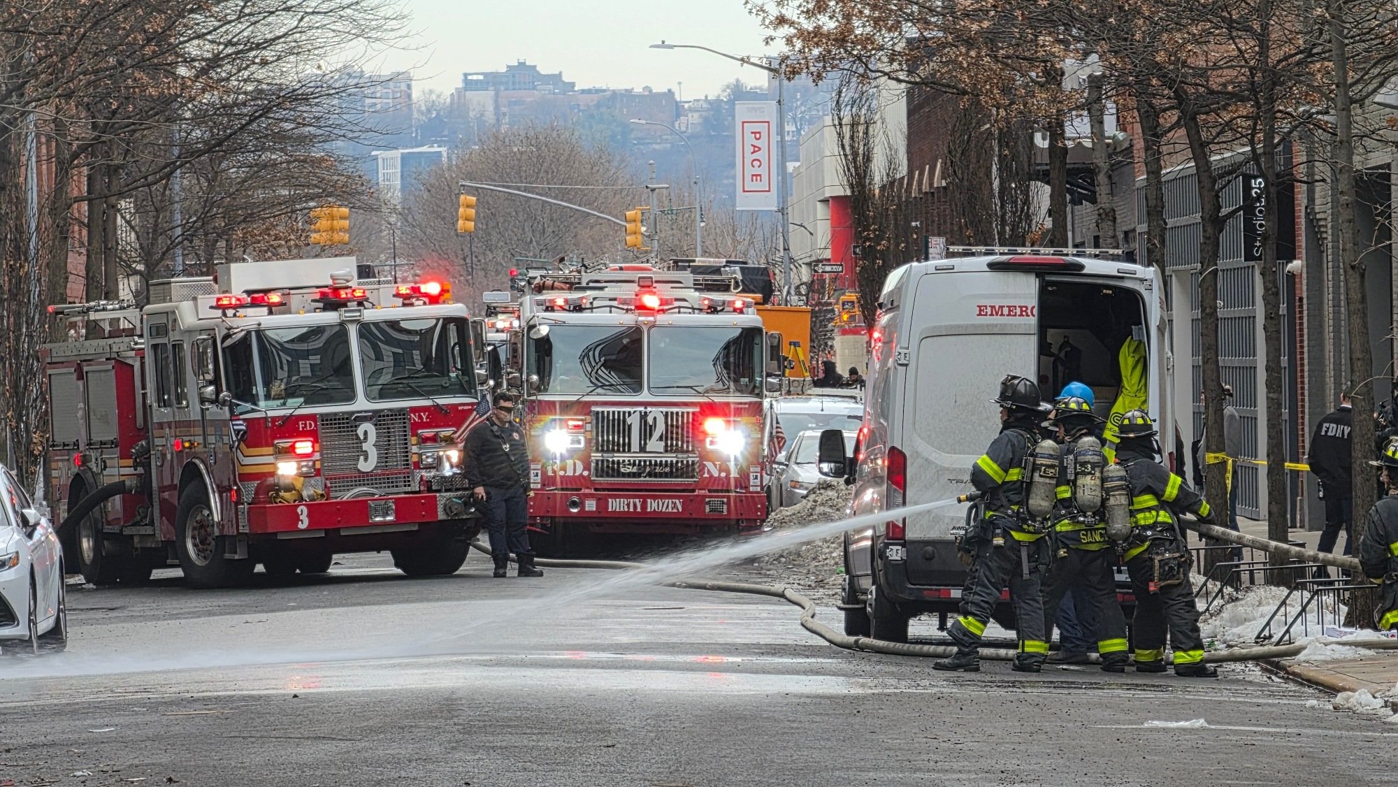 new york city firefighters putting out a fire on the street