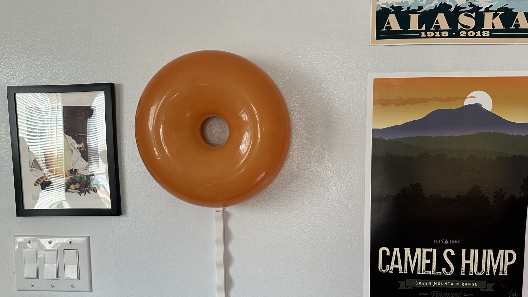 An IKEA Varmblixt lamp hanging on the wall