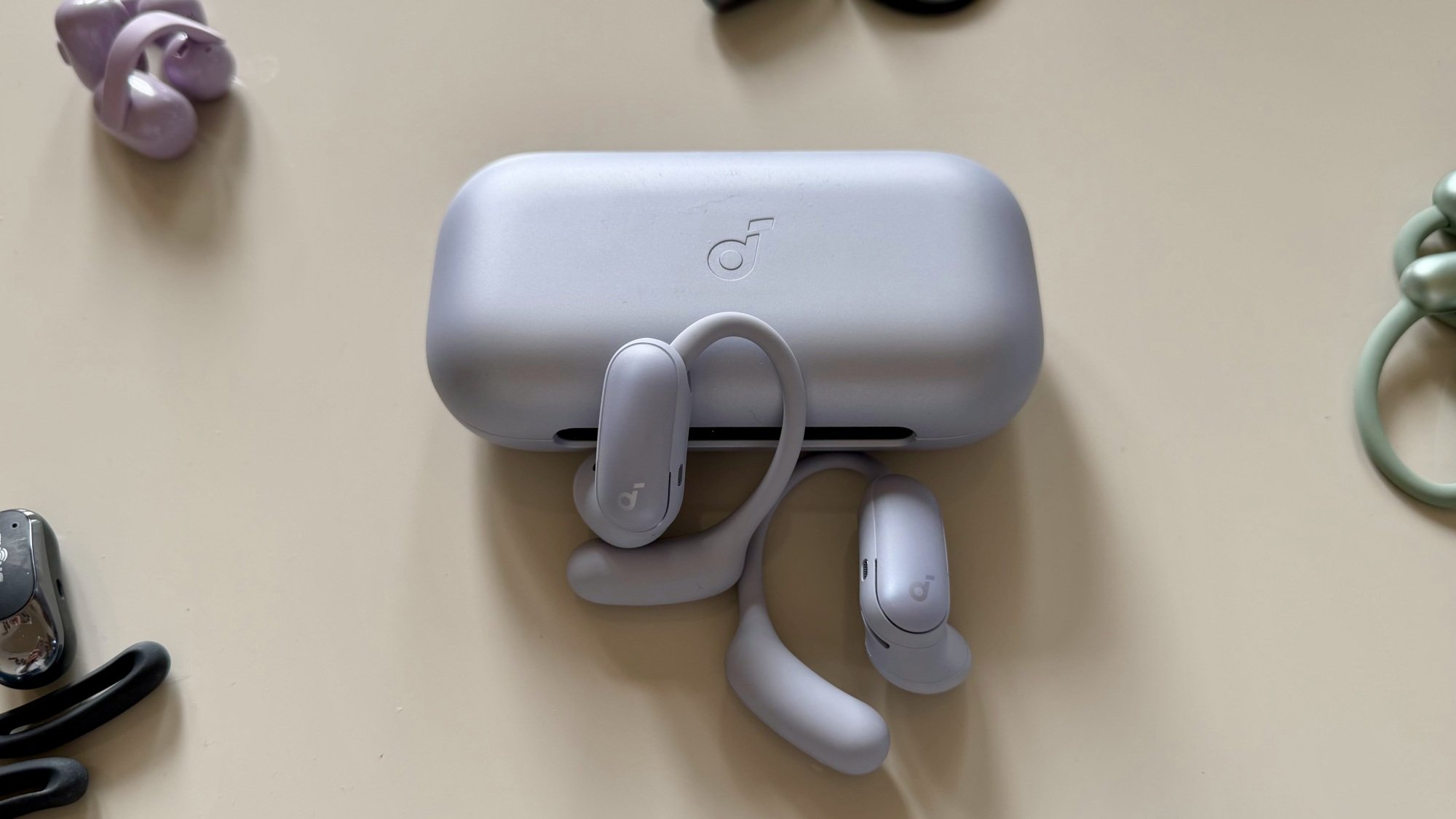 soundcore aerofit 2 pro earbuds surrounded by other open earbuds