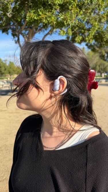 profile of woman wearing soundcore aerofit pro 2 earbuds in open mode