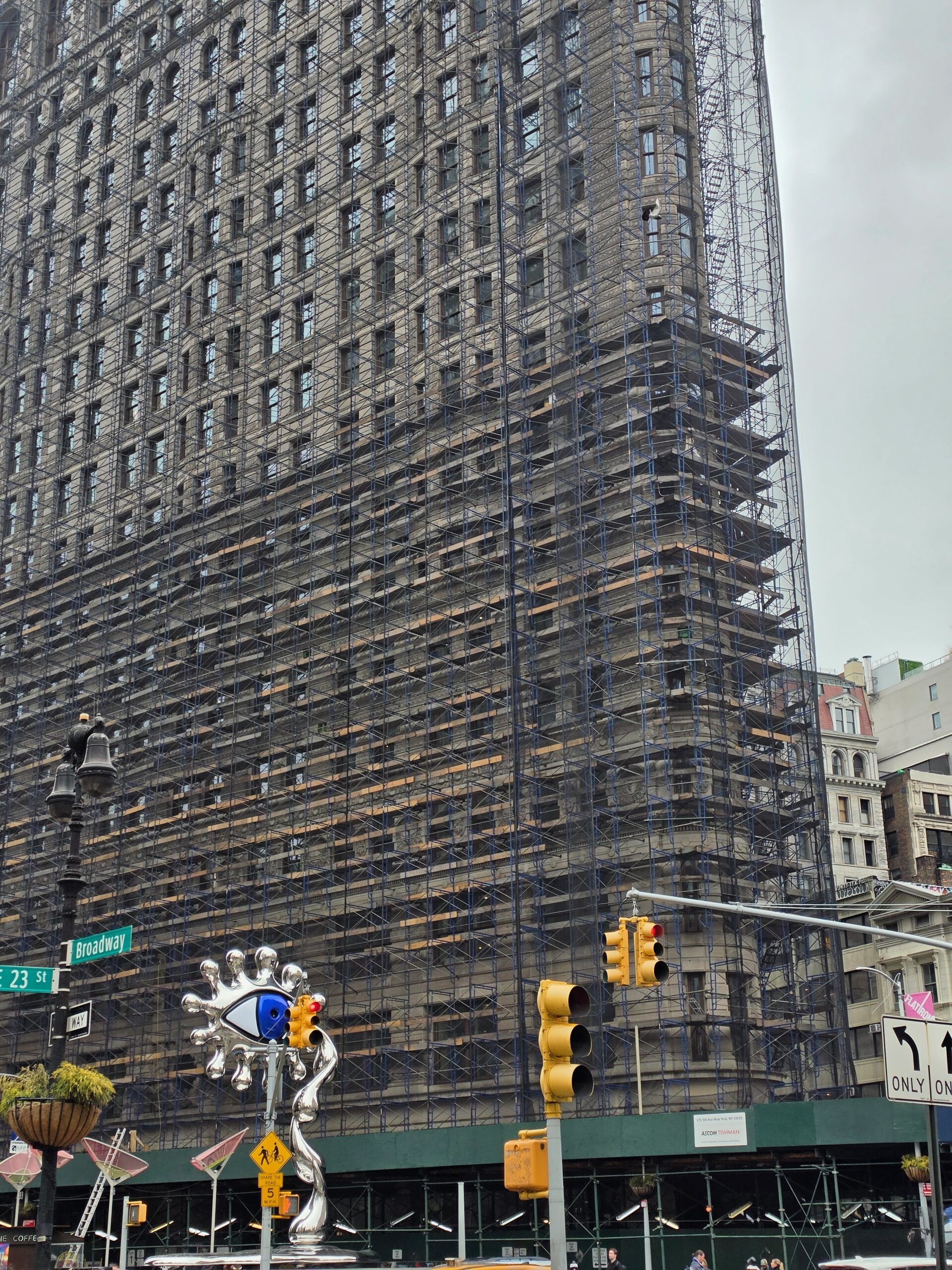 flat iron building in new york covered in scaffolding