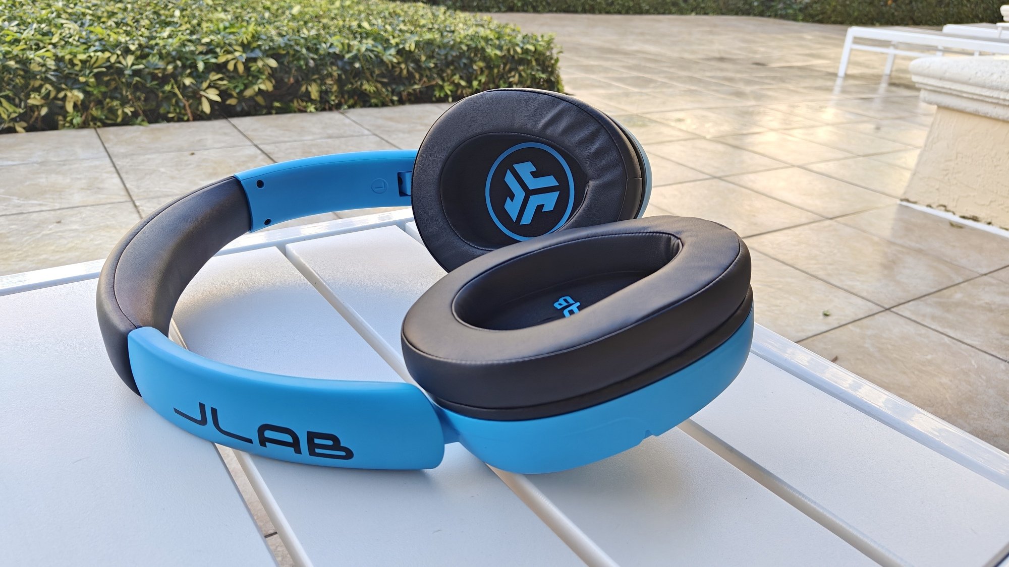 jlab Blue XL Speaker Headphones on pool deck