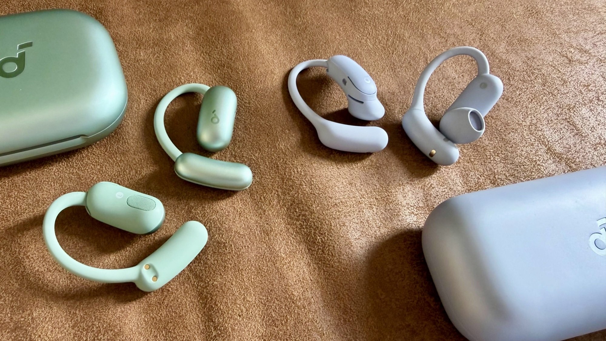 aerofit 2 earbuds and case next to soundcore aerofit 2 pro earbuds and case