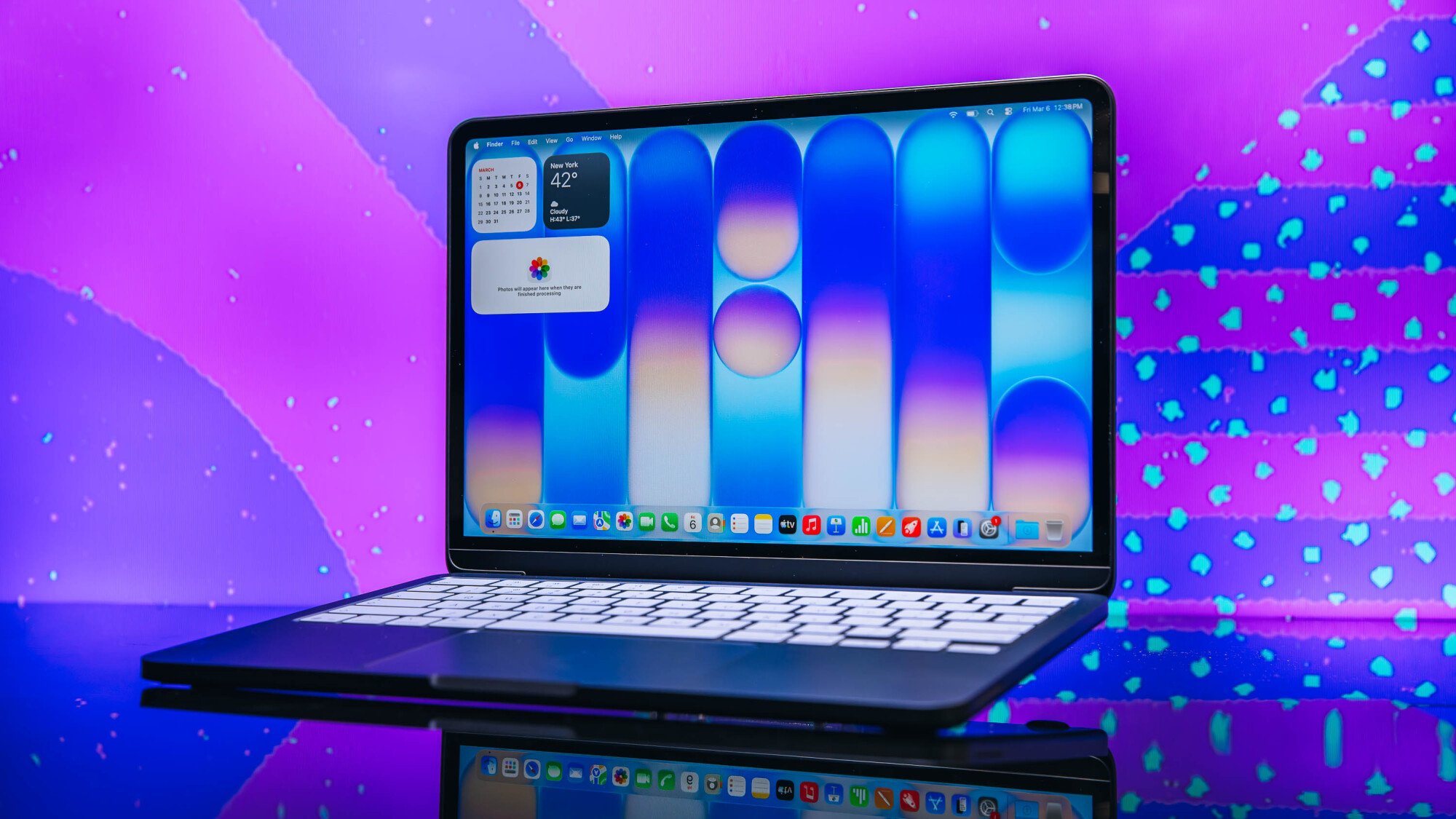 apple macbook neo posed in front of purple background