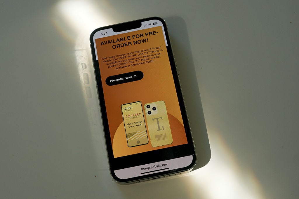 iPhone with Trump Mobile website on its screen