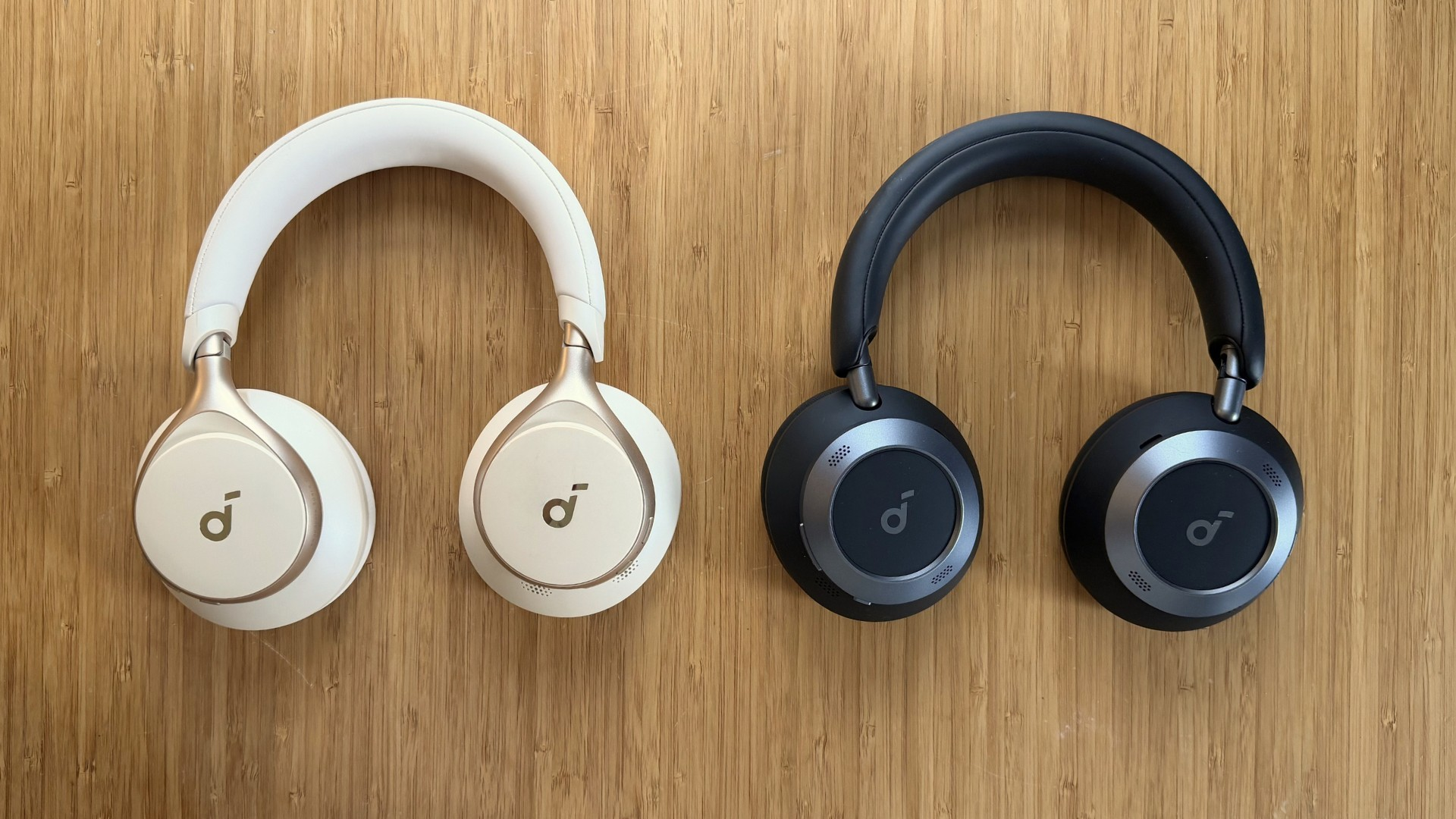 On the left, a pair of Soundcore Space One headphones and on the right, a pair of Space One Pro headphones.