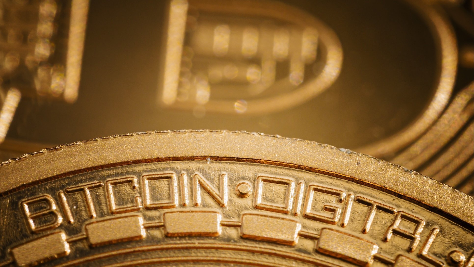 Bitcoin cryptocurrency logo is shown on a coin