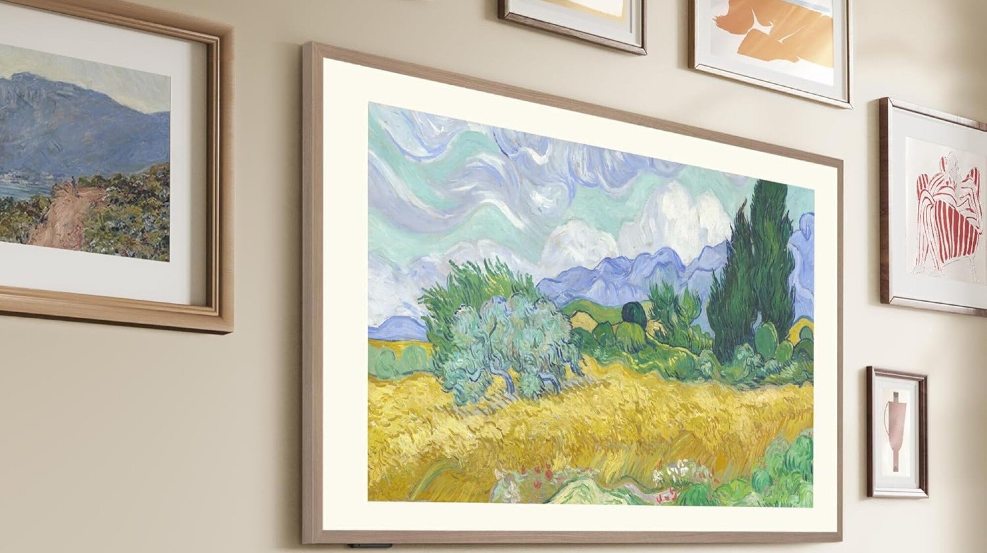 the hisense canvasTV on a wall with other framed art