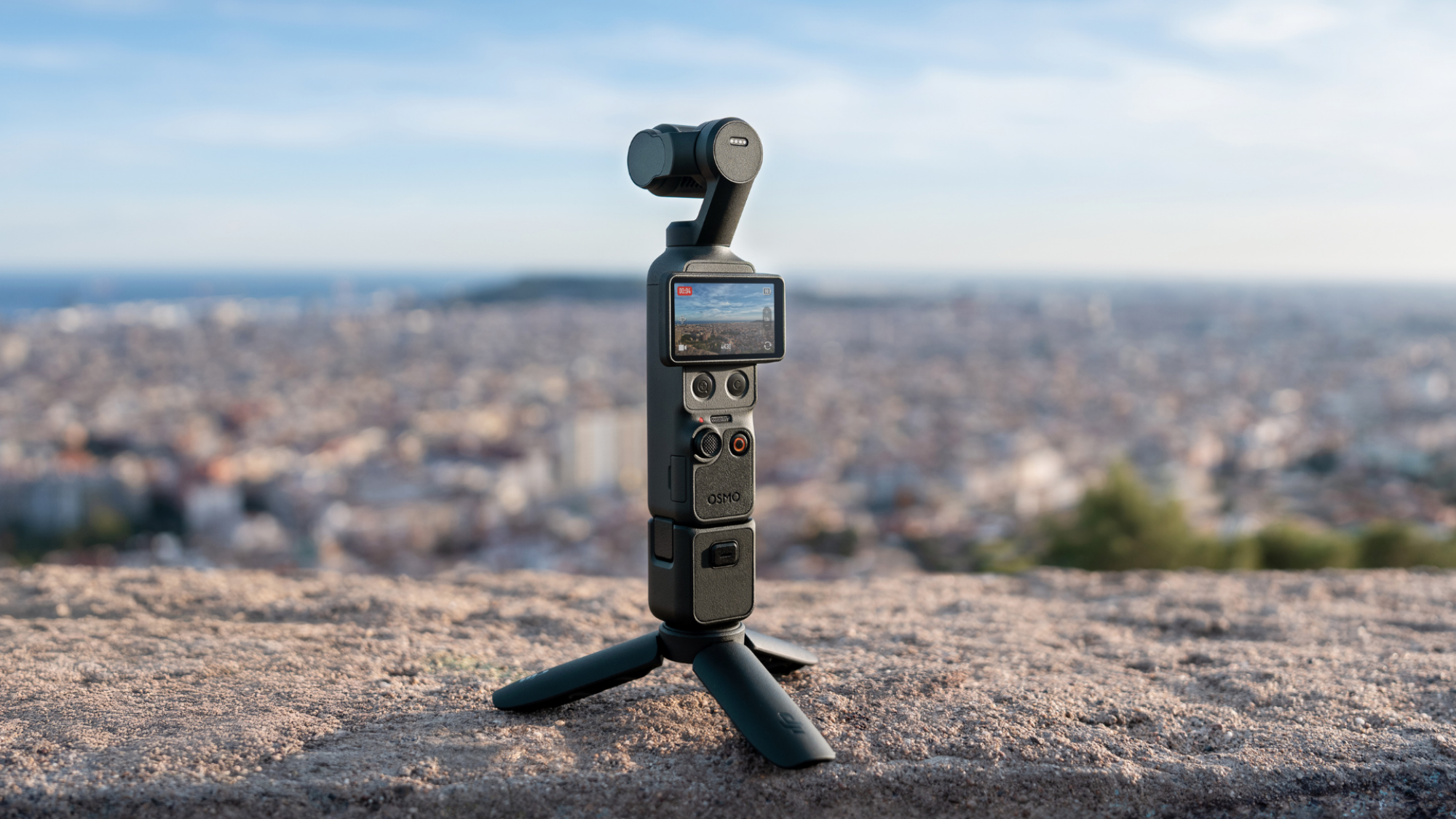 The DJI Osmo Pocket 4 camera standing on tripod legs.