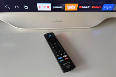 Hisense D&eacute;co TV remote laying on dresser near TV