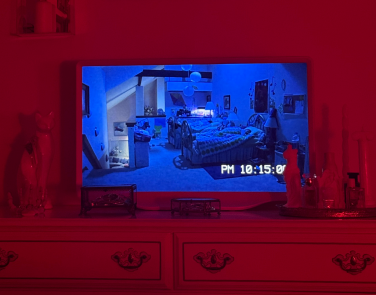 Hisense D&eacute;co TV sitting on dresser while playing a scene from "Paranormal Activity 3"