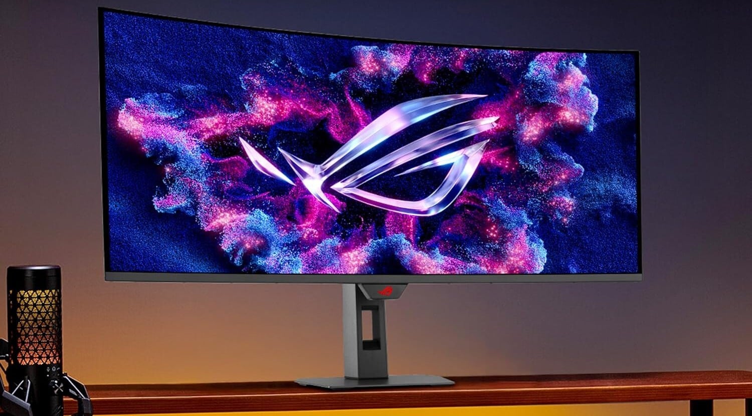 the asus rog strix 43-inch gaming monitor on a desktop in a dimly lit room