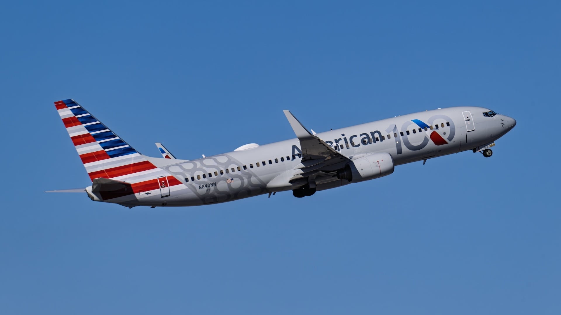 An American Airlines plane in the sky.