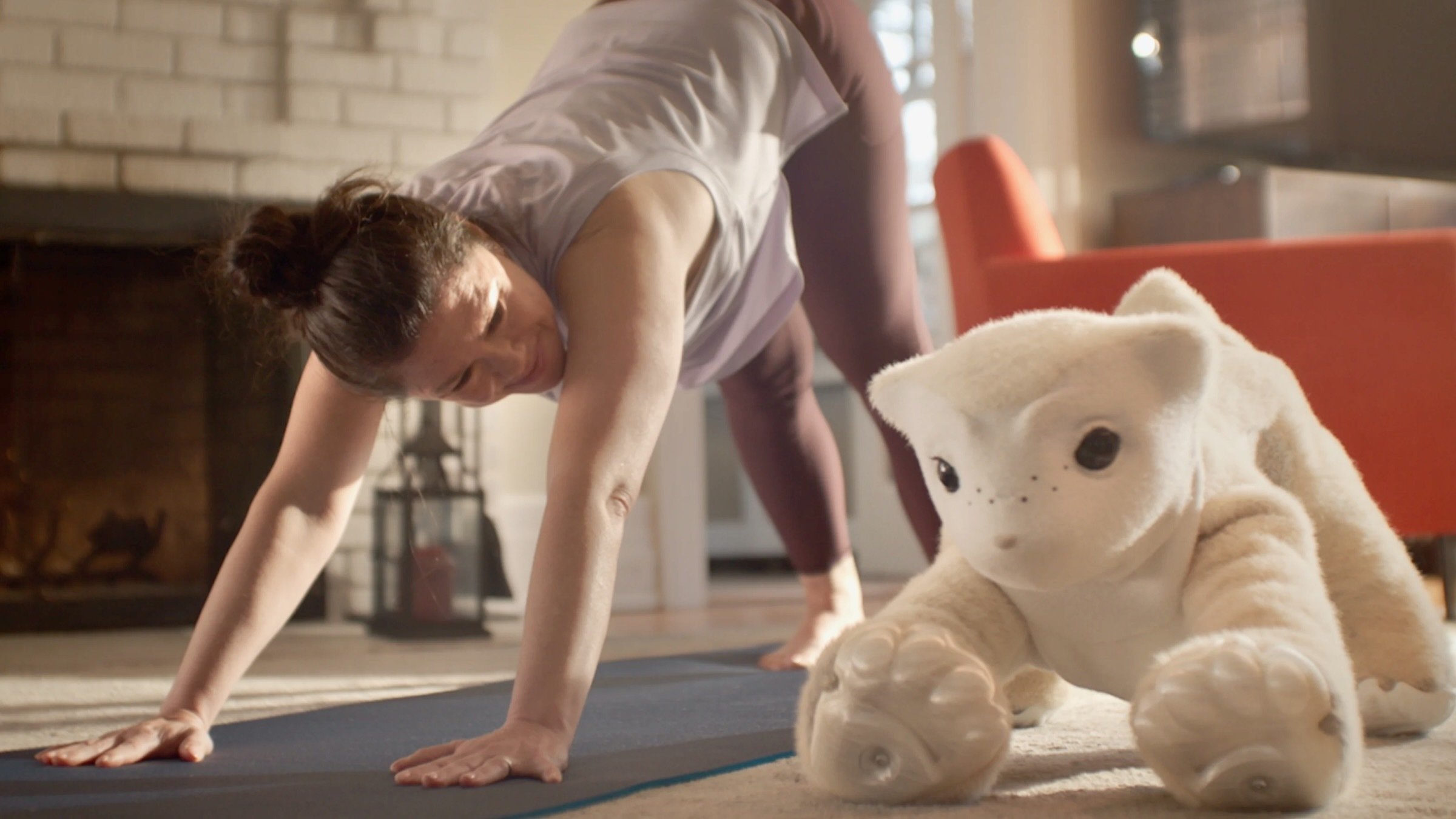 woman doing yoga with familiar machine's familiar companion robot