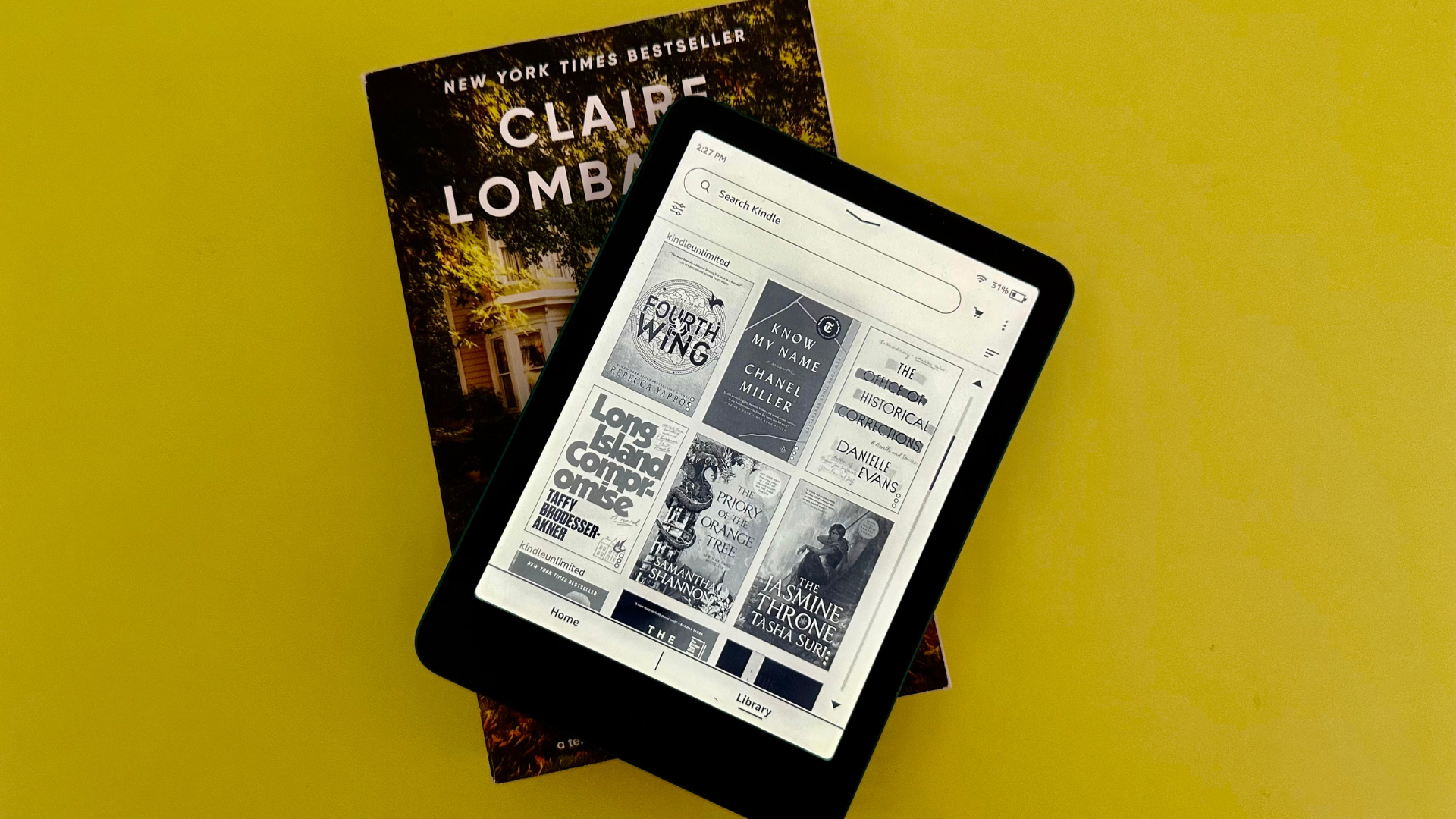 A Kindle Paperwhite Signature Edition on top of a book