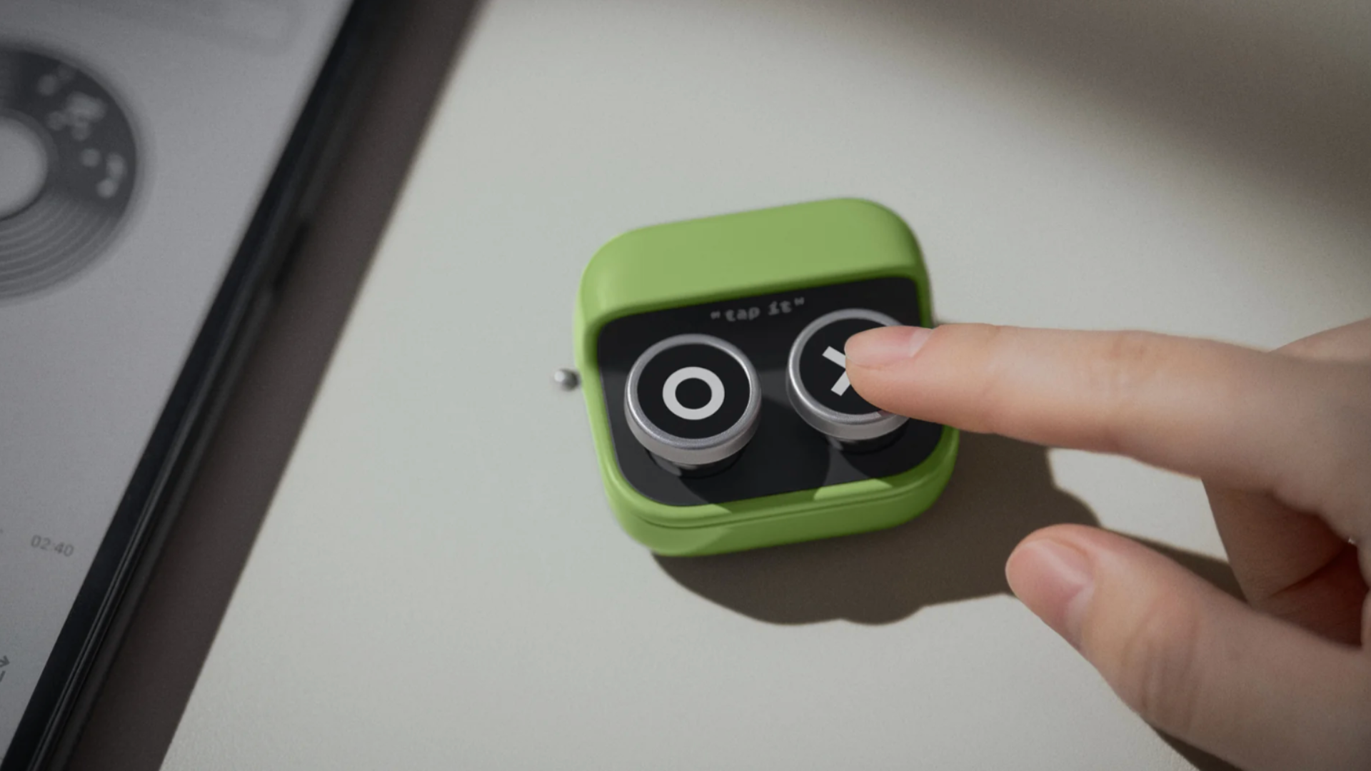 A hand pressing the Boox Tappy wireless remote