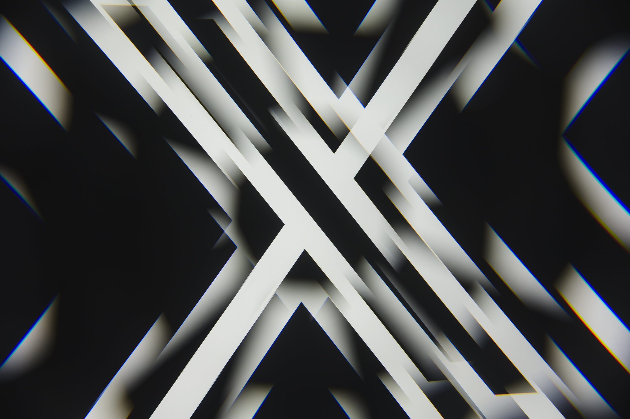 A kaleidoscopic picture of a black and white X logo.