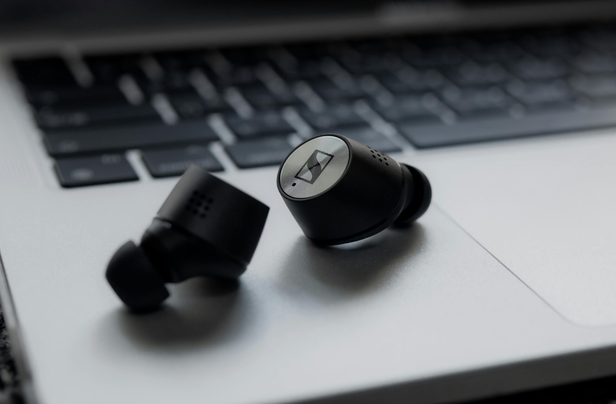 Earbuds sat on laptop