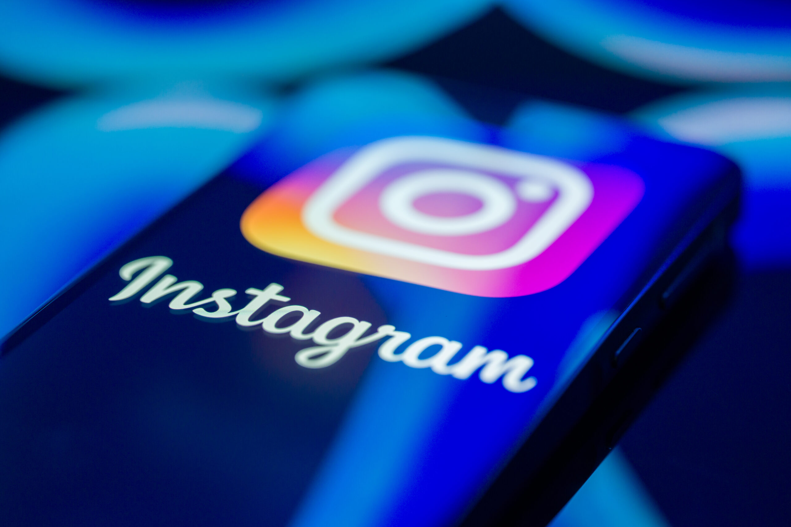 A phone displays the Instagram logo.