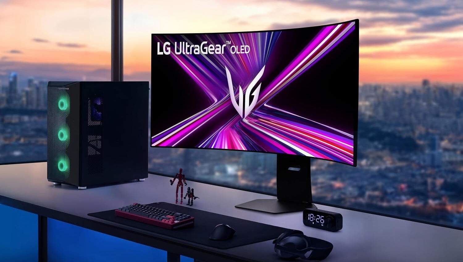 the LG Ultragear monitor on a desktop in front of high-rise windows at sunset