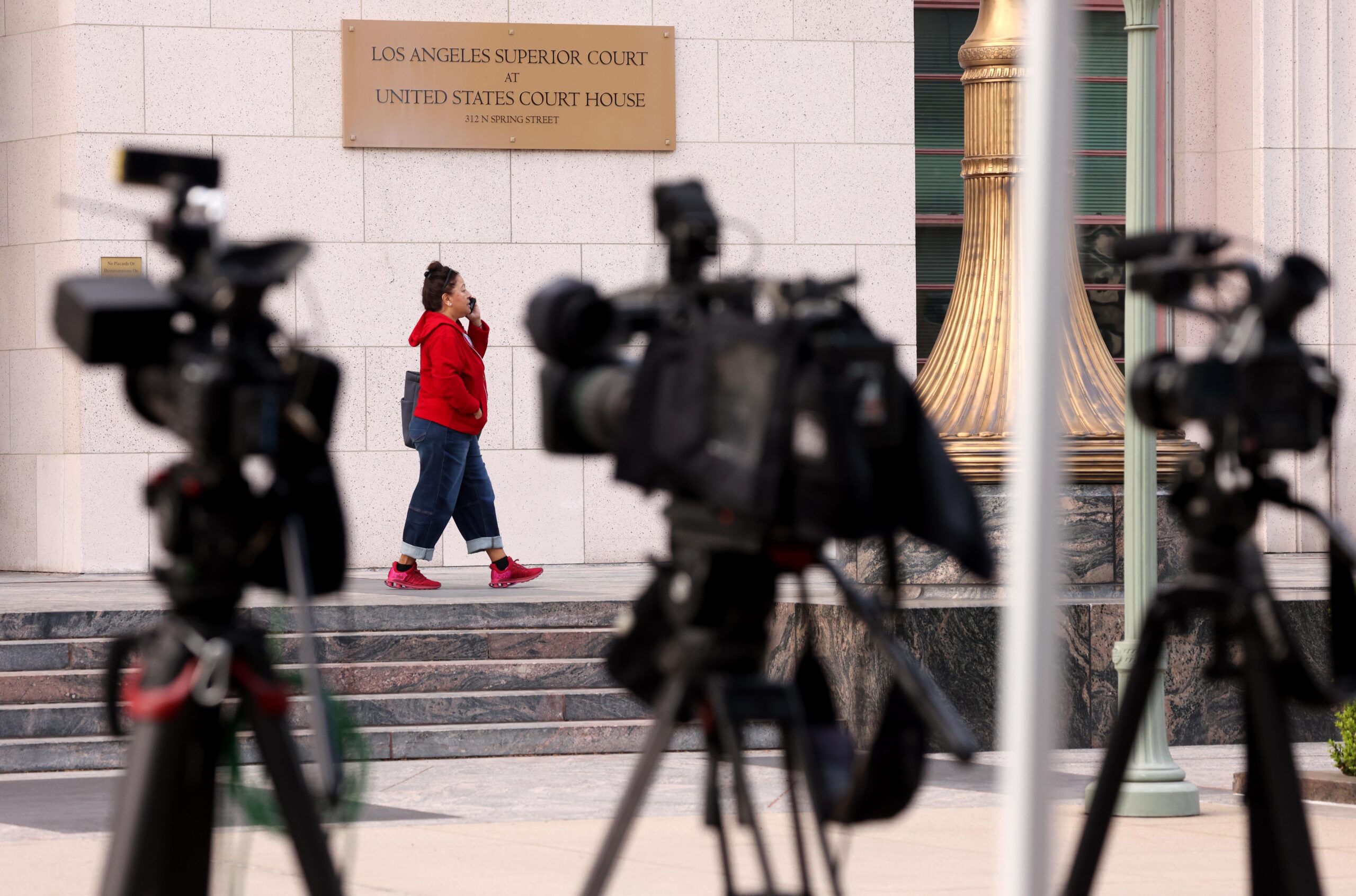 A row of cameras set up near the steps of the Los Angeles County Superior Court building.