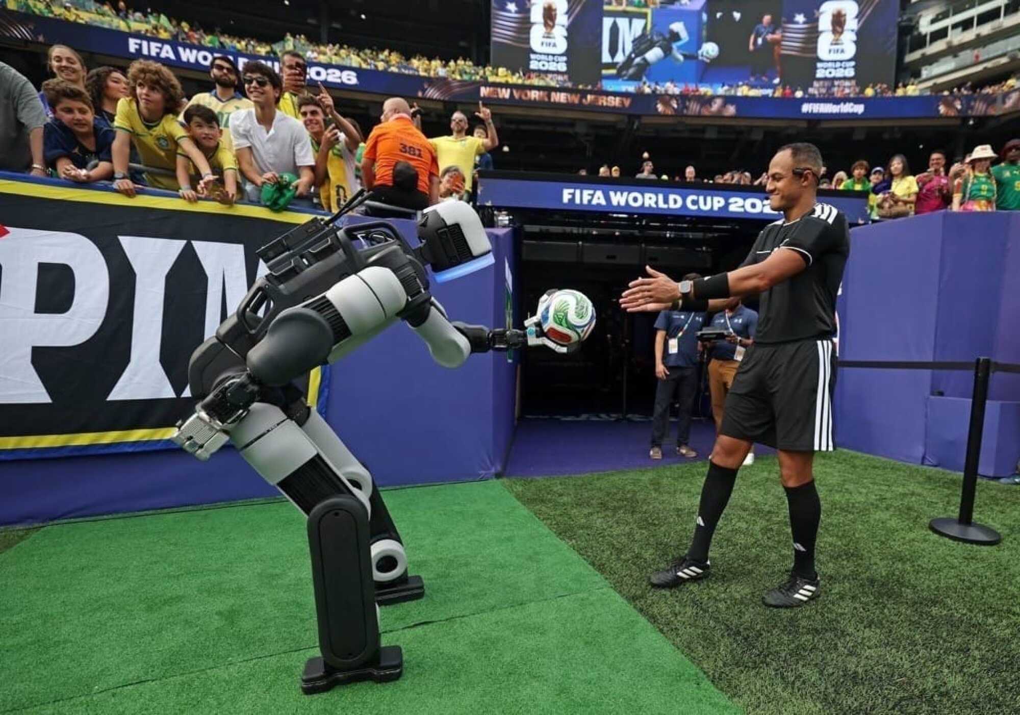 Atlas hands off the match ball to the ref at the half.